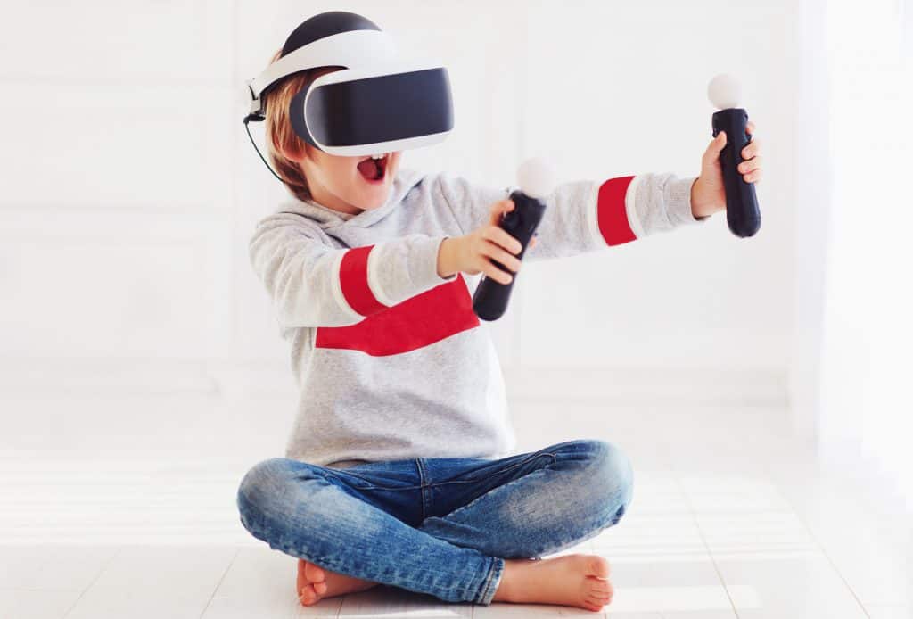 young boy uses virtual reality with a headset